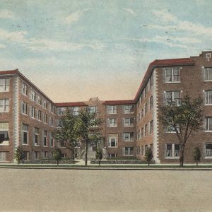 Two wings of a multistory brick building