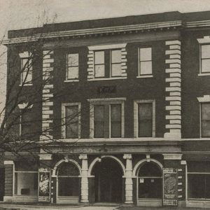 Multistory corner brick building with arched entrance