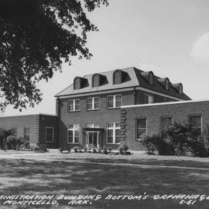 Multistory brick building with two single story wings