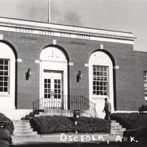 One story brick building with arched doorway and windows