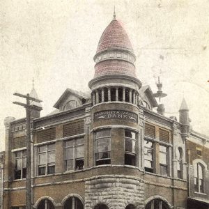 Stone and brick multistory building with large cupola over the entrance