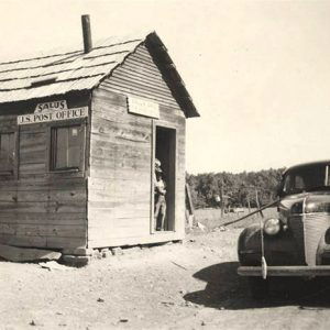 Car parked in front of small wooden shack