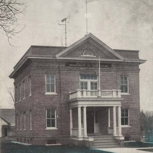 Two story red brick building with covered entrance