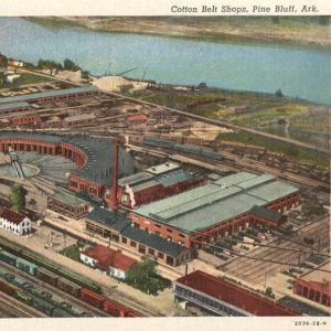 Large group of buildings between railroad tracks and river