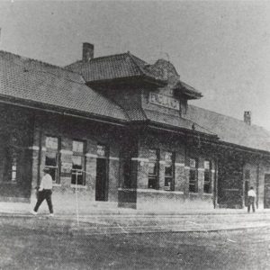 Single story building with man walking in foreground