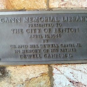 Bronze memorial plaque attached to rock wall