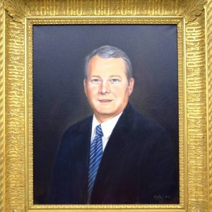 Painting in gold frame of white man in blue suit with striped tie