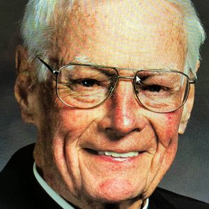 older white man in glasses and clerical collar