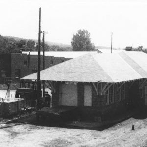 Single story building beside railroad tracks