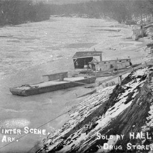 Barge and houseboat on frozen river