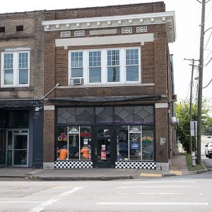 Multistory brick building with traffic beside it