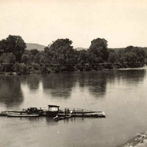 Ferry carrying a car across a river