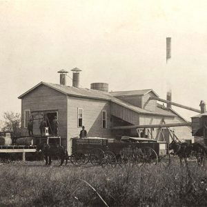 Multistory buidings with farm equipment and people