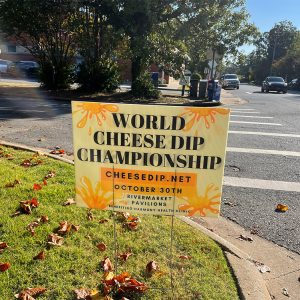 Yard sign next to street saying "World Cheese Dip Championship"