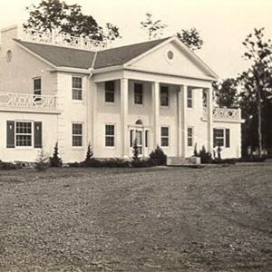 Multistory white building with covered porch