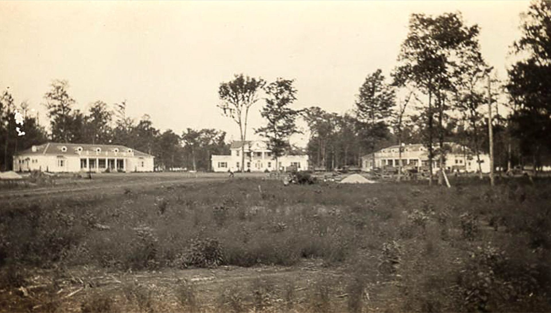 Three white buildings as seen from a distance