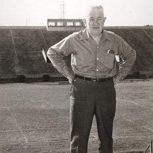 White man standing in bleachers at sports stadium