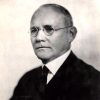 White man in suit and glasses