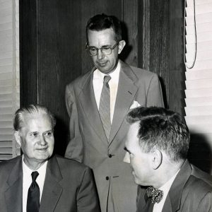 Three white men in suits and ties