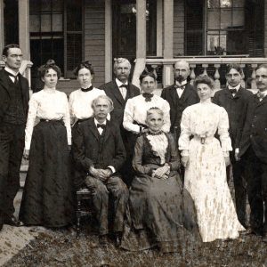 Large group of formally dressed white men and women posing for photo