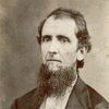 White man with long beard posing for portrait