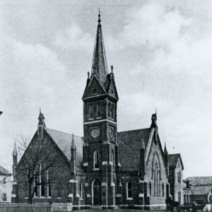 Multistory brick church building with bell tower