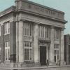 Stone two-story building with front-facing columns "Farmers State Bank"