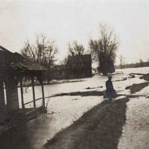 wrecked wooden house in floodwater