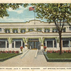 Multistory white stucco building with draping surrounding windows