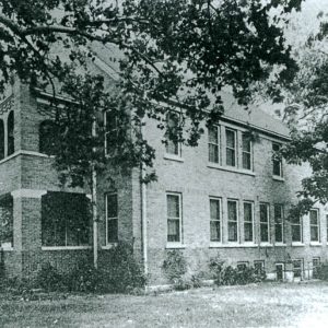 Multistory brick building with stacked covered porches