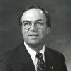 White man with glasses in suit and tie