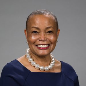 Portrait of African American woman wearing large pearl necklace