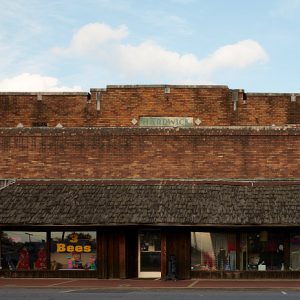 Multistory red brick building with shake awning