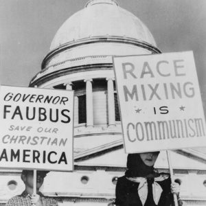 White people holding signs with "Race Mixing is Communism" and other slogans