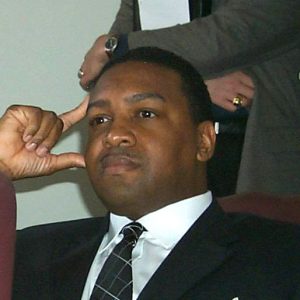 African American man touching his head with thumb and forefinger