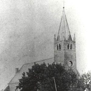 stone church building with tall clock tower