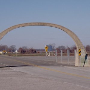 Concrete arch straddling highway and saying "Entering Arkansas"