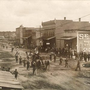 Parade on dirt street in downtown area