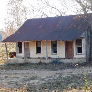 abandoned looking wooden house with metal roof