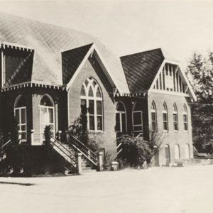 Multistory brick church building with arched windows