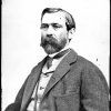 man in suit and tie with mustache and short beard