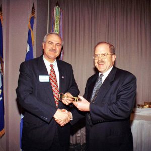 Two white men in suits shaking hands