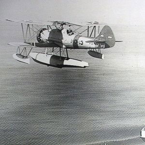 Military airplane flying over water