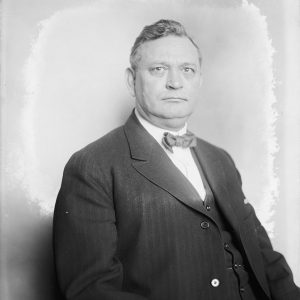 White man in suit with bow tie