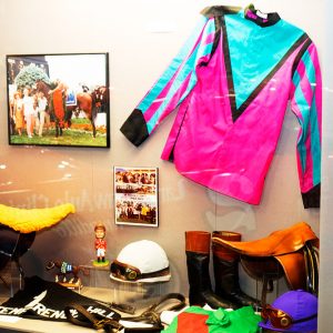 Display featuring jockey clothing and accoutrements