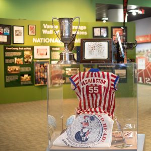 Display of red and white striped shirt and trophy