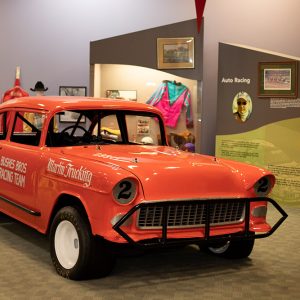 Red-orange car on display with a 2 on the side