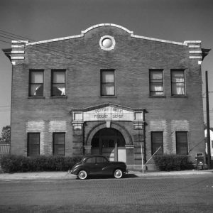 Multistory brick building with arched entrance