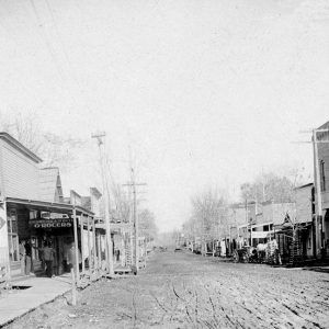 Dirt road between two rows of wooden buildings