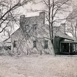 Old two-story wooden house on wooded lot